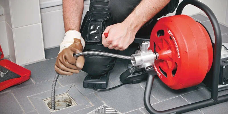 Plumber using a drain-cleaning machine in Jacksonville Beach