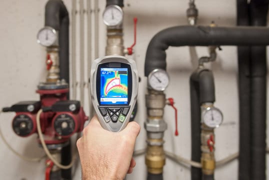 Plumber using a thermal imaging camera to inspect pipes in Jacksonville Beach