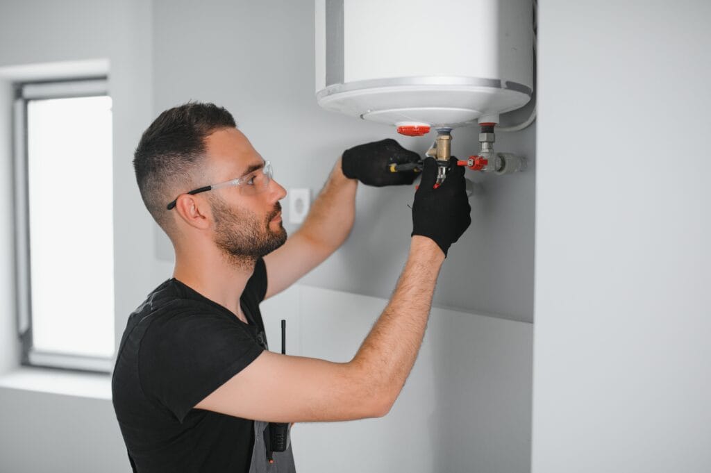 Technician performing water heater maintenance in Jacksonville Beach